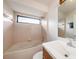 Classic bathroom with a tub/shower combo, window, and vanity at 31645 Bugle Ln, Wesley Chapel, FL 33543