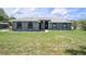 Single-story home with a well-maintained lawn and an attractive facade on a clear day at 31645 Bugle Ln, Wesley Chapel, FL 33543