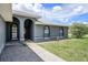 Charming exterior view showcasing arched windows and a well-manicured lawn at 31645 Bugle Ln, Wesley Chapel, FL 33543