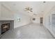 Spacious living room featuring tile floors, a fireplace, and French doors for natural light at 31645 Bugle Ln, Wesley Chapel, FL 33543