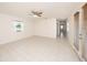 Large living room with tile floors, ceiling fan and natural light at 31645 Bugle Ln, Wesley Chapel, FL 33543