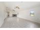 Open living space featuring tile flooring, a cozy fireplace, and plenty of natural light at 31645 Bugle Ln, Wesley Chapel, FL 33543