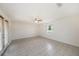 Large living room with tile floors, ceiling fan and lots of natural light at 31645 Bugle Ln, Wesley Chapel, FL 33543