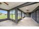 Spacious screened patio with dark grey columns and ceilings at 31645 Bugle Ln, Wesley Chapel, FL 33543