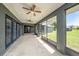 Large, screened patio with ceiling fans and dark grey columns at 31645 Bugle Ln, Wesley Chapel, FL 33543