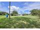 View of the home with large open green area at 31645 Bugle Ln, Wesley Chapel, FL 33543