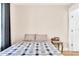 Bedroom with a small side table and a large window with blinds at 340 6Th E St, Bradenton, FL 34208