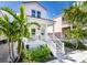 Charming two-story home with a welcoming front porch and beautiful landscaping with palm trees at 340 6Th E St, Bradenton, FL 34208