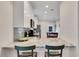 Modern kitchen featuring stylish gray countertops, white cabinetry, and stainless steel appliances at 340 6Th E St, Bradenton, FL 34208
