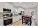 Bright kitchen with stainless steel appliances, a breakfast bar, and wood floors offer a modern cooking space at 340 6Th E St, Bradenton, FL 34208