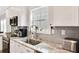Modern kitchen featuring a window, stainless steel appliances, and stone countertops at 340 6Th E St, Bradenton, FL 34208