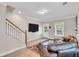 Open-concept living room with hardwood floors, large TV, and comfortable seating at 340 6Th E St, Bradenton, FL 34208