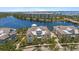 Aerial view of the yellow townhome, nestled beside a serene lake at 340 Sapphire Lake Dr # 202, Bradenton, FL 34209