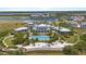 Stunning aerial view of a luxury community clubhouse, pool, and beautiful waterfront at 340 Sapphire Lake Dr # 202, Bradenton, FL 34209
