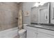 Tiled bathroom featuring granite counters, white cabinets, toilet, shower and tub at 340 Sapphire Lake Dr # 202, Bradenton, FL 34209