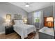 This bedroom offers hardwood floors, a ceiling fan, and natural light at 340 Sapphire Lake Dr # 202, Bradenton, FL 34209