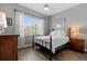 Bright bedroom featuring hardwood floors, gray walls, ceiling fan and window letting in natural light at 340 Sapphire Lake Dr # 202, Bradenton, FL 34209