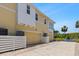 Yellow two-story home with a two-car garage and exterior features at 340 Sapphire Lake Dr # 202, Bradenton, FL 34209