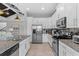 Bright kitchen featuring white cabinetry, stainless steel appliances, and granite countertops at 340 Sapphire Lake Dr # 202, Bradenton, FL 34209