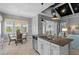 Eat-in kitchen with a round table, stainless appliances, and waterfront views through large windows at 340 Sapphire Lake Dr # 202, Bradenton, FL 34209