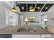 Open-concept living room featuring dark ceiling beams, pendant lighting, and modern decor at 340 Sapphire Lake Dr # 202, Bradenton, FL 34209