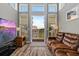 Bright living room featuring wood floors, neutral walls, large window and brown leather couch at 340 Sapphire Lake Dr # 202, Bradenton, FL 34209