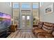Bright living room featuring wood floors, neutral walls, large window and brown leather couch at 340 Sapphire Lake Dr # 202, Bradenton, FL 34209