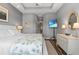 The bedroom has a TV, bright windows and an ensuite bathroom with a walk-in shower and vanity at 340 Sapphire Lake Dr # 202, Bradenton, FL 34209