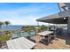 Outdoor dining area features tables and chairs overlooking the pool, waterway and bay at 340 Sapphire Lake Dr # 202, Bradenton, FL 34209
