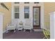 Inviting porch featuring wicker chairs, a small table, and charming decor at 340 Sapphire Lake Dr # 202, Bradenton, FL 34209