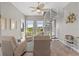 Bright sunroom features a spiral staircase, armchairs, and serene water views at 340 Sapphire Lake Dr # 202, Bradenton, FL 34209