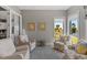 Cozy sitting area with comfortable recliners, patterned chairs, and sunny backyard views at 340 Sapphire Lake Dr # 202, Bradenton, FL 34209