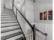 Bright staircase with black handrail and art on the wall at 340 Sapphire Lake Dr # 202, Bradenton, FL 34209
