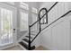 Modern staircase with sleek black handrail, white risers, and neutral wall paint at 340 Sapphire Lake Dr # 202, Bradenton, FL 34209