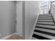 View of staircase with gray walls, black treads and white risers at 340 Sapphire Lake Dr # 202, Bradenton, FL 34209