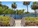 Scenic walkway leading to a tranquil waterfront view surrounded by lush landscaping at 340 Sapphire Lake Dr # 202, Bradenton, FL 34209
