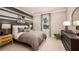 This bedroom boasts a gray and white striped accent wall, plush carpet, and a comfortable queen size bed with soft, neutral bedding at 3411 Lumber Falls Dr, Plant City, FL 33565