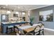 Modern kitchen featuring stainless steel appliances, a kitchen island, and an adjacent dining area with stylish decor at 3411 Lumber Falls Dr, Plant City, FL 33565