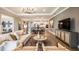 Open-concept living room and dining area showcasing hardwood floors, neutral decor, and abundant natural light at 3411 Lumber Falls Dr, Plant City, FL 33565