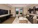 Comfortable living room with a modern sofa, sleek entertainment center, and stylish decor at 3411 Lumber Falls Dr, Plant City, FL 33565