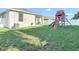 Spacious backyard with play set and patio area perfect for entertaining at 3512 Gerrads Cross Ct, Land O Lakes, FL 34638