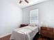 Cozy bedroom with hardwood floors, neutral walls, and a bright window at 3512 Gerrads Cross Ct, Land O Lakes, FL 34638