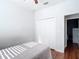 Cozy bedroom featuring hardwood floors and a closet with white bi-fold doors at 3512 Gerrads Cross Ct, Land O Lakes, FL 34638