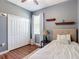 Comfortable bedroom with window, closet, lamp, decorative shelves, and golf sign at 3512 Gerrads Cross Ct, Land O Lakes, FL 34638