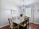 Elegant dining area with a chandelier and a large window at 3512 Gerrads Cross Ct, Land O Lakes, FL 34638