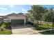 Charming single-story home with a well-manicured lawn and a two-car garage at 3512 Gerrads Cross Ct, Land O Lakes, FL 34638