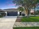 Charming single-story home with a well-manicured lawn and a two-car garage at 3512 Gerrads Cross Ct, Land O Lakes, FL 34638