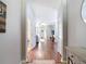 Inviting hallway with hardwood floors leading to the living area at 3512 Gerrads Cross Ct, Land O Lakes, FL 34638