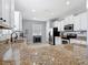 Bright kitchen with stainless steel appliances, granite countertops and white cabinetry at 3512 Gerrads Cross Ct, Land O Lakes, FL 34638
