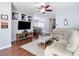 Living room featuring hardwood floors, a ceiling fan, and comfortable seating at 3512 Gerrads Cross Ct, Land O Lakes, FL 34638